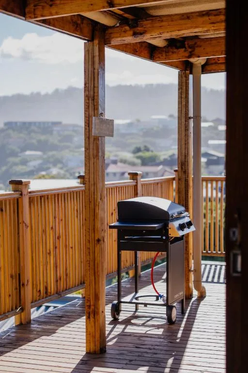Wooden deck with braai grill overlooking scenic mountain and valley landscape views