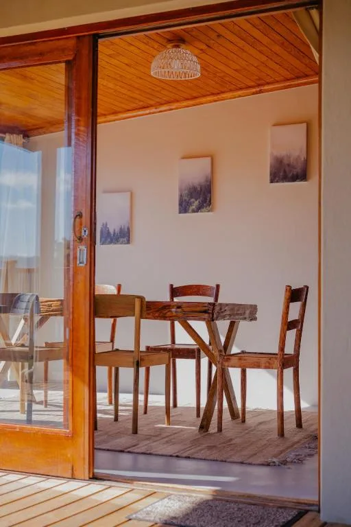 Wooden dining table with chairs in bright, minimalist space