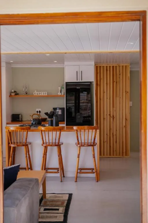 Modern kitchen with wooden bar seating and stainless steel appliances