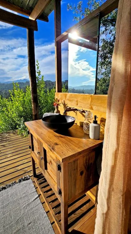Outdoor bathroom vanity with black vessel sink overlooking mountains