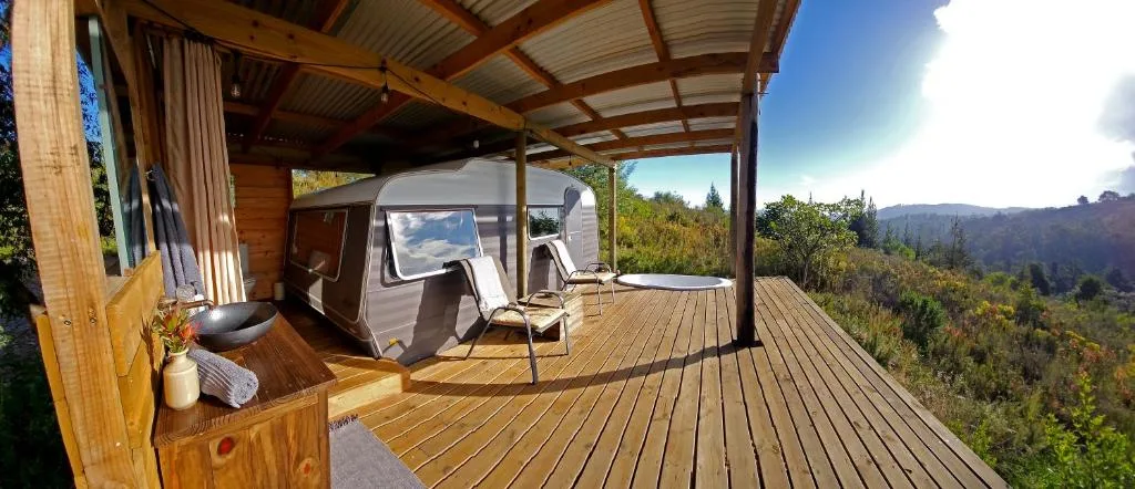 Wooden deck with covered pavilion, outdoor seating, and mountain views