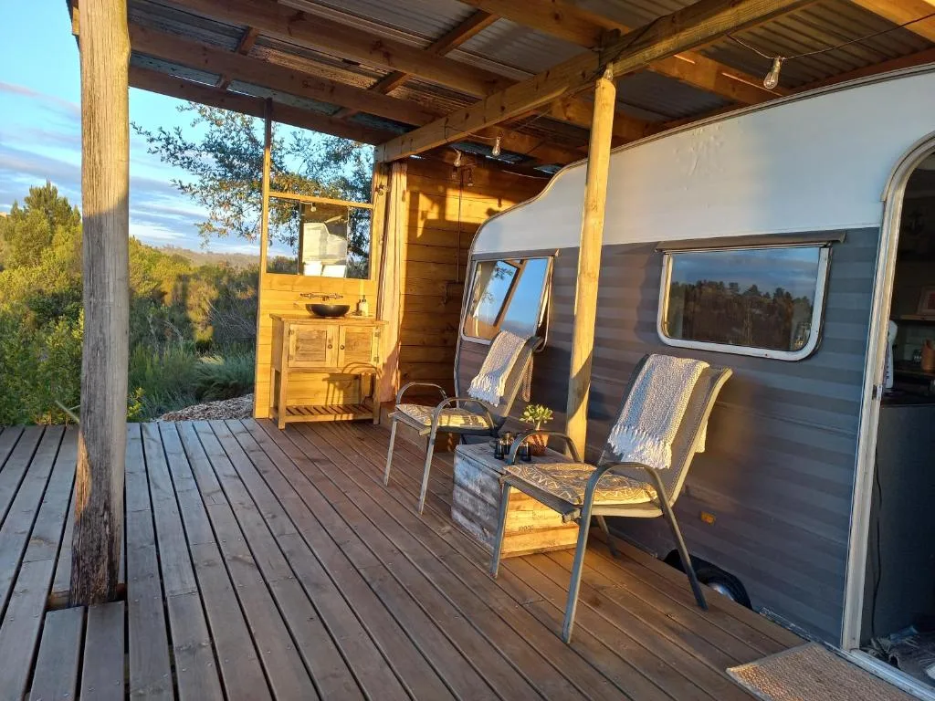 Wooden deck with comfortable seating chairs overlooking garden route landscape