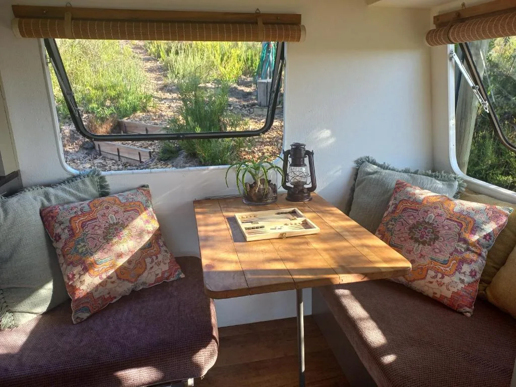 Cozy interior seating nook with wooden table and colorful cushions