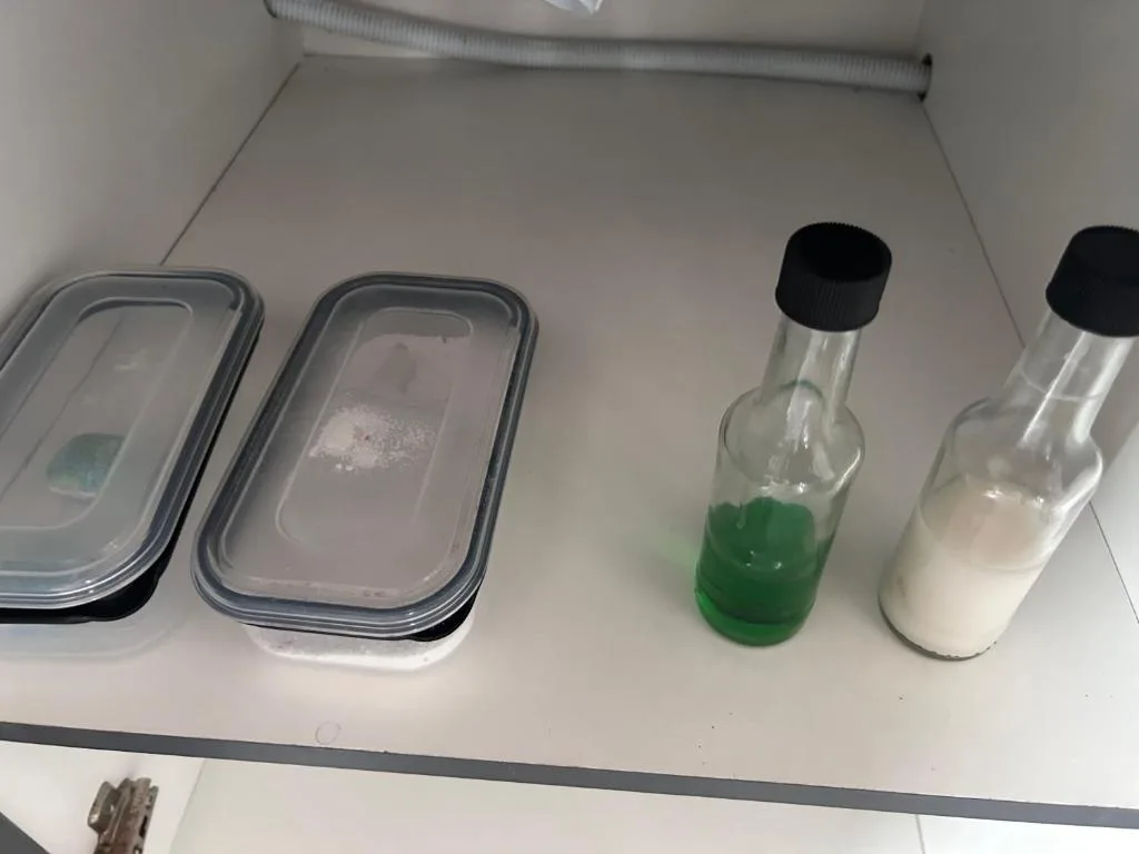 Refrigerator shelf with storage containers and condiment bottles