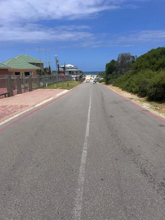 Driveway approach to residential property with green-roofed buildings and sea views