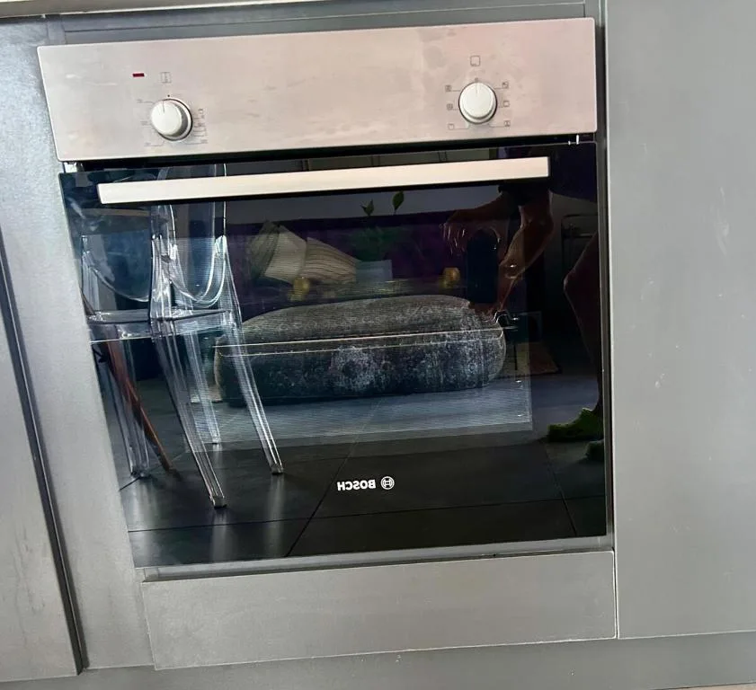 Built-in Bosch oven with stainless steel controls and dark interior