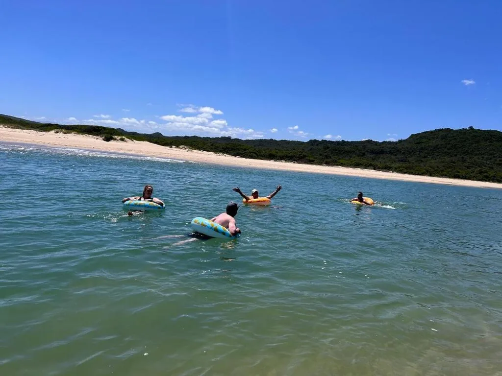 Beautiful sandy beach with turquoise waters and lush green hills