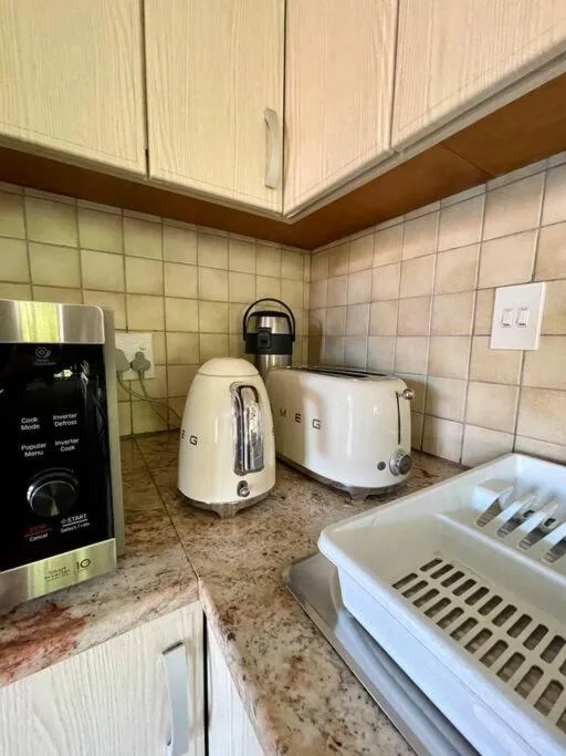 Kitchen countertop with cream appliances and cream cabinetry above