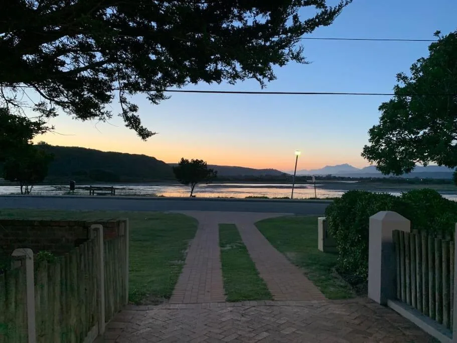 Scenic lagoon sunset view with mountains and peaceful waterside landscape