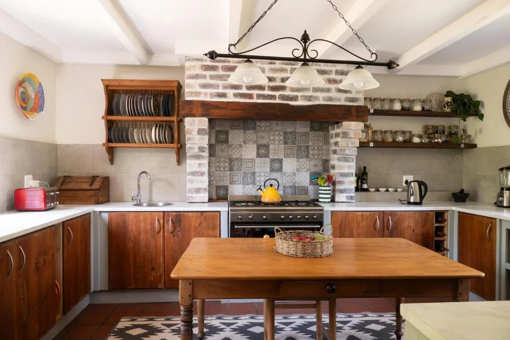 Spacious kitchen with wooden cabinetry, brick fireplace, and dining table