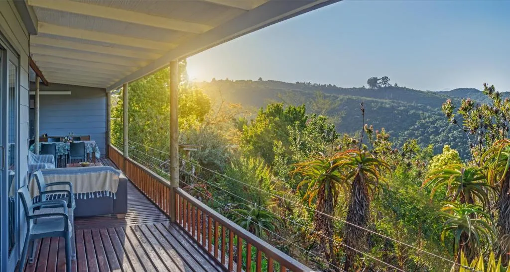 Covered wooden deck with panoramic mountain views and lush vegetation