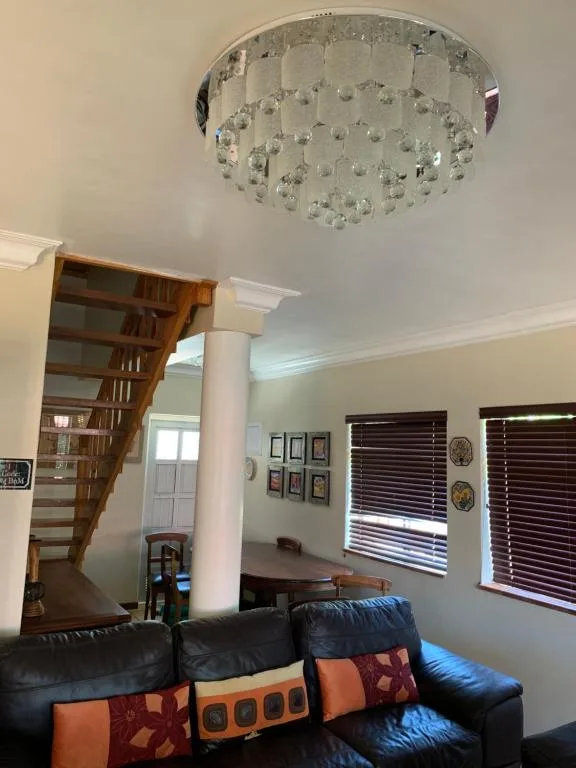 Modern lounge with black leather sofa and decorative pillows