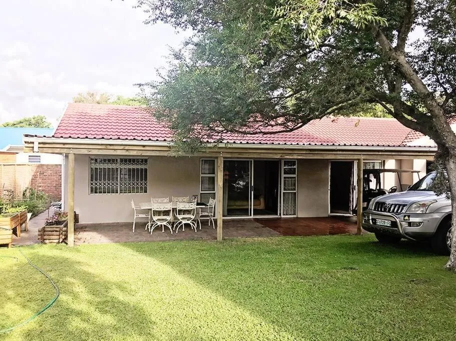 Single-storey holiday home with red tile roof and covered patio area