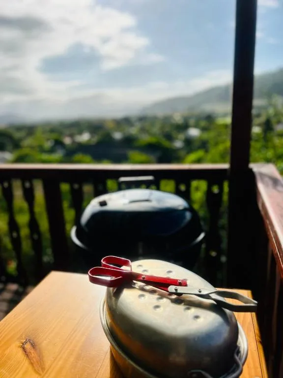 Braai grill on wooden deck with scenic valley views beyond