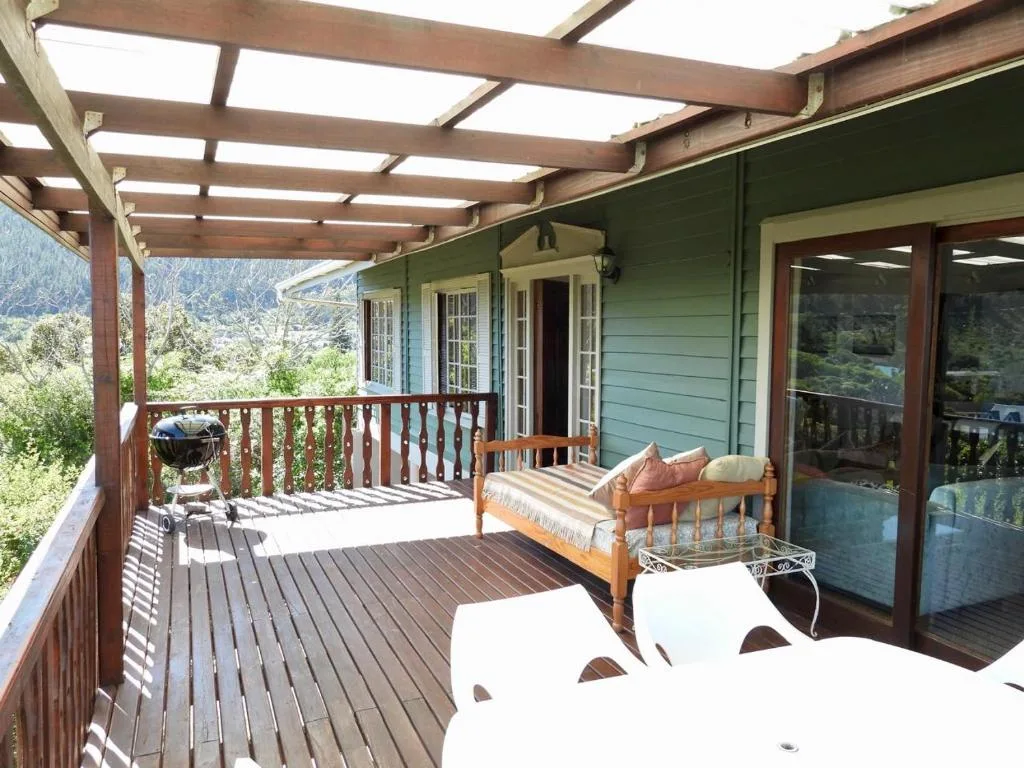 Wooden deck with pergola, seating, and mountain valley views