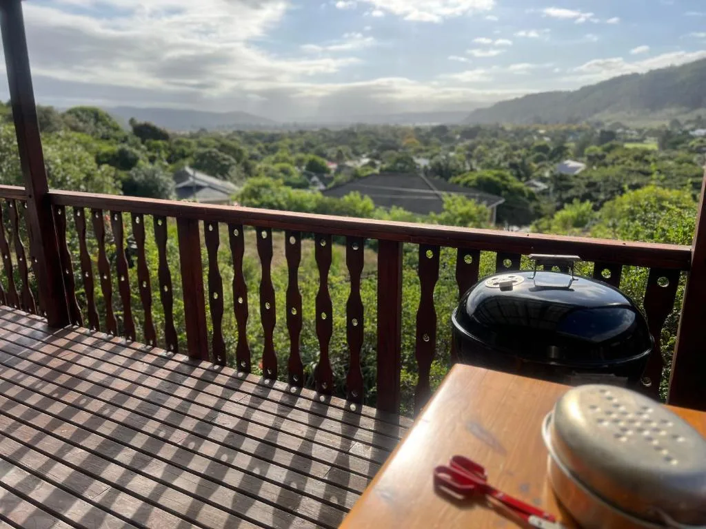 Scenic valley and mountain vista from elevated deck with railing