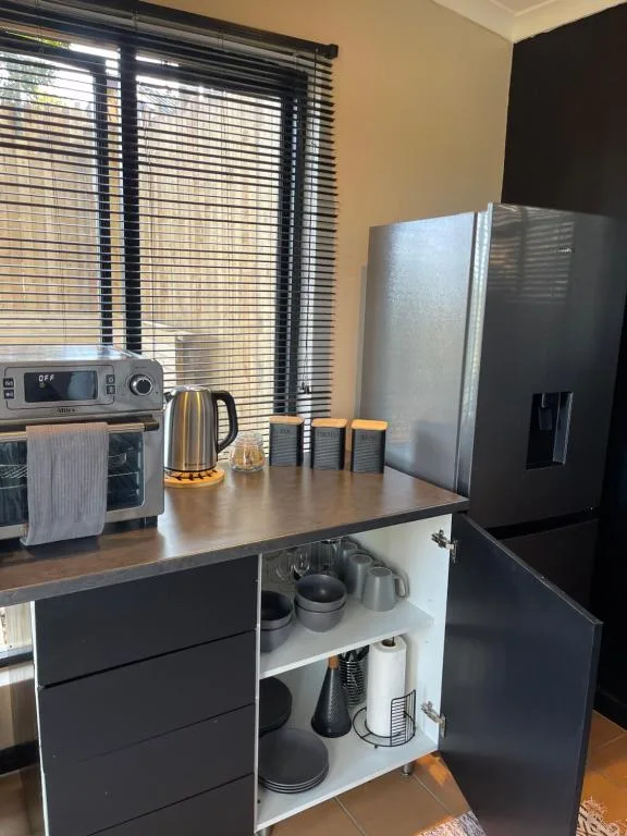 Modern kitchen with stainless steel appliances and dark cabinetry