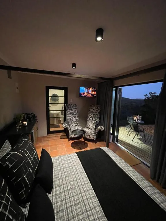 Modern lounge with seating, fireplace, and sliding doors opening to deck