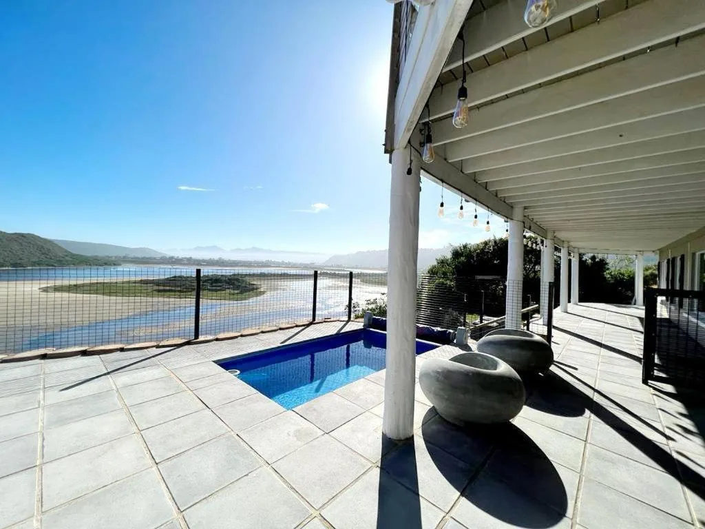 Covered patio with private pool overlooking Sedgefield Lagoon on sunny day