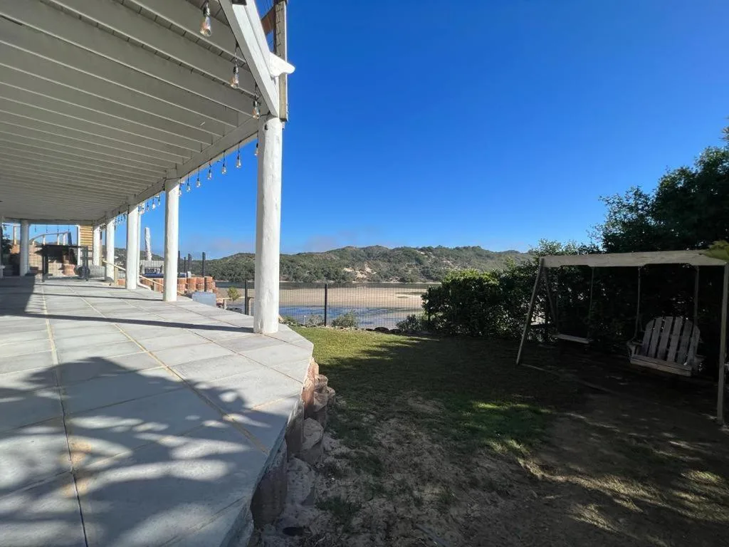 Covered patio with columns overlooking lagoon and mountains