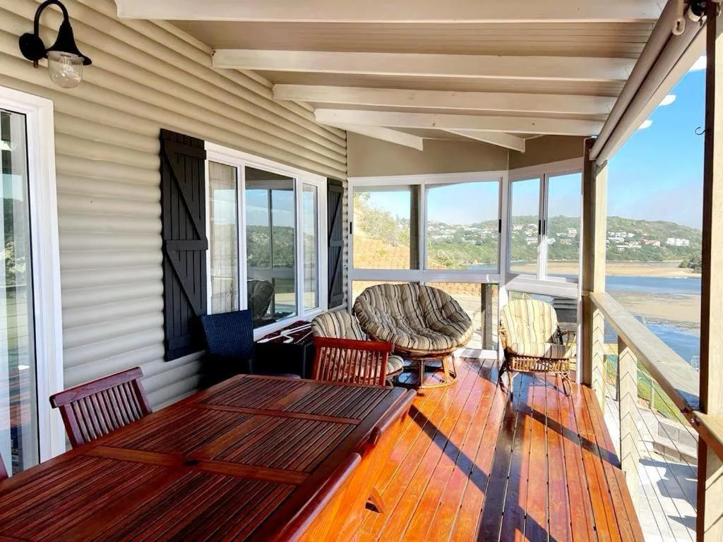 Wooden deck with seating overlooking Sedgefield lagoon and beach views