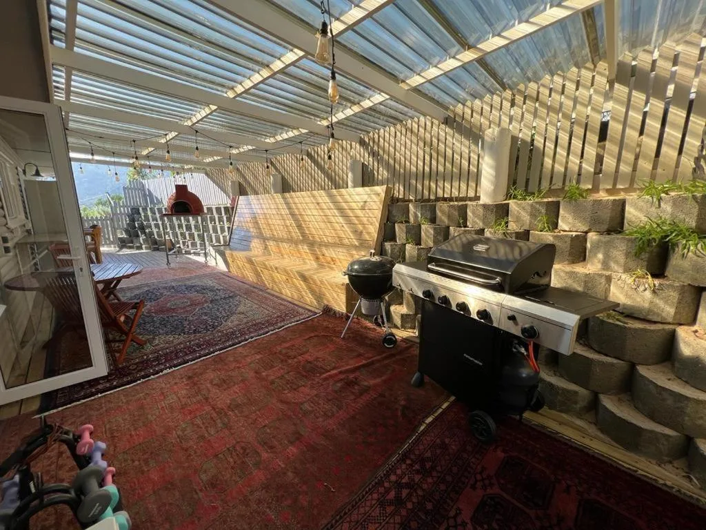 Covered outdoor entertainment area with braai grill and seating