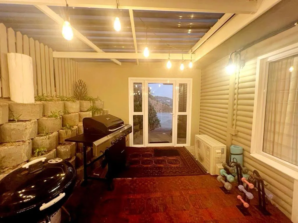 Indoor entertainment space with piano, braai area, and lagoon views