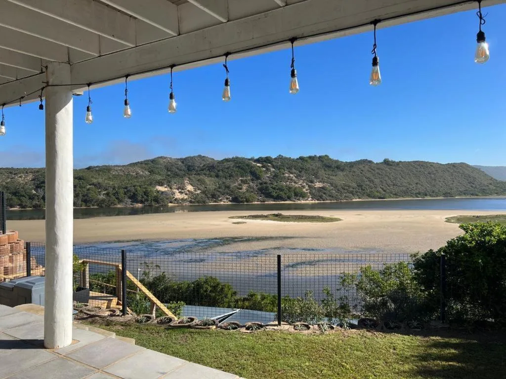 Sedgefield Lagoon and mountains viewed from shaded deck with hanging lights