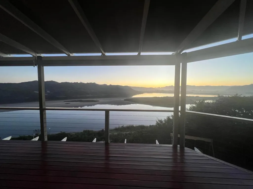Sunrise over Sedgefield Lagoon viewed from covered deck with mountains