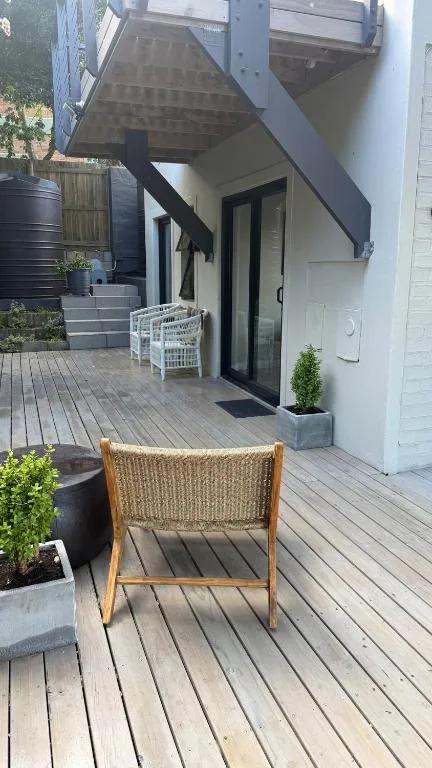 Wooden deck with wicker chair and outdoor seating area