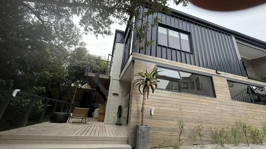 Modern apartment exterior with wooden deck and contemporary architectural design