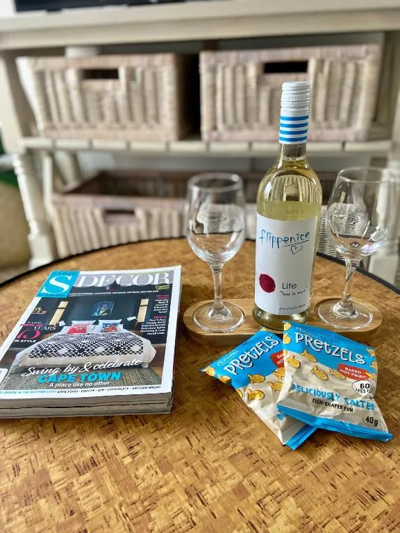 Welcome table with white wine, glasses, snacks, and local magazines