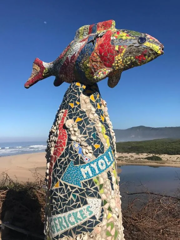 Colorful mosaic fish sculpture overlooking Sedgefield beach and lagoon