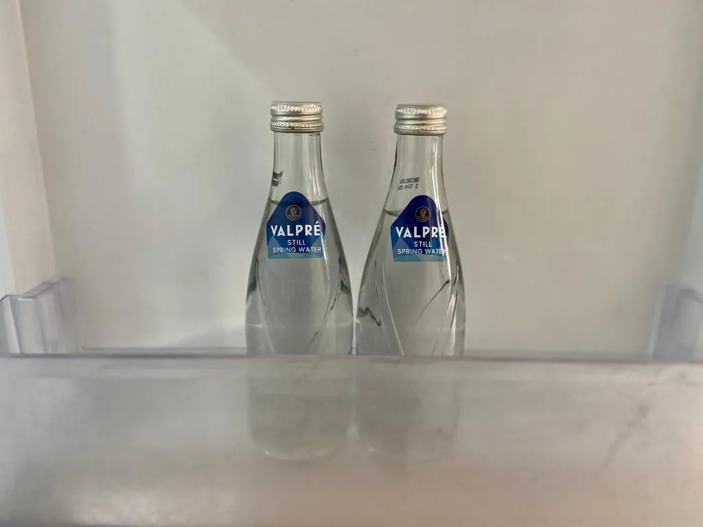 Two bottles of Valpré still spring water in refrigerator