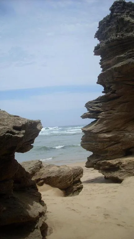 Rocky coastal beach with ocean waves and dramatic rock formations