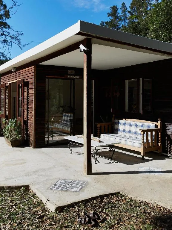 Modern cabin patio with covered seating area and outdoor furniture