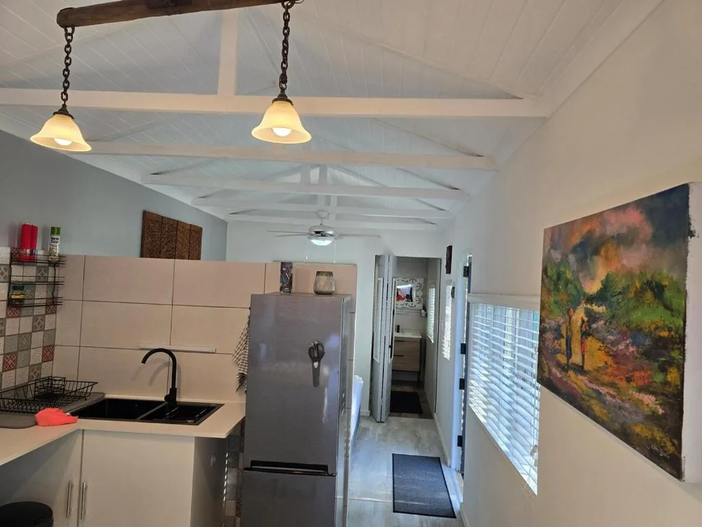 Modern kitchen with stainless steel appliances and pendant lighting