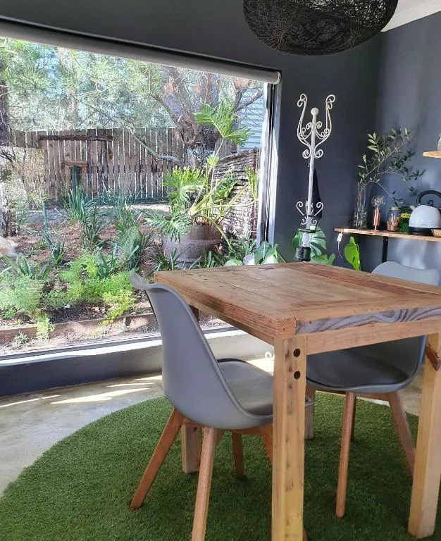 Modern dining table with garden view through large sliding doors
