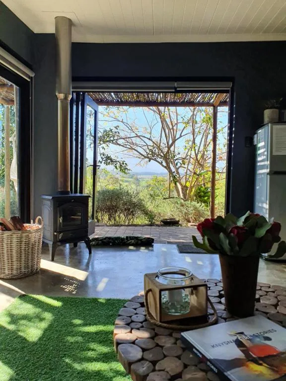 Modern lounge with wood stove, opening onto scenic mountain views