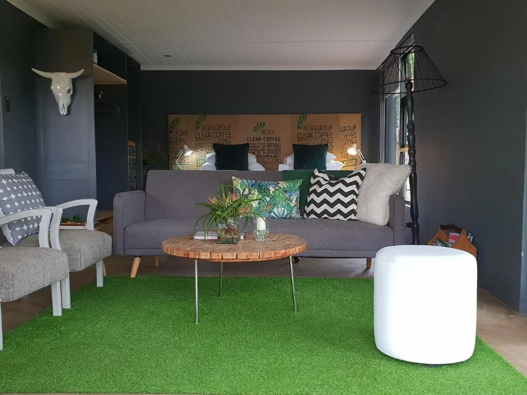 Modern lounge with gray sofa, round wooden table, and contemporary decor