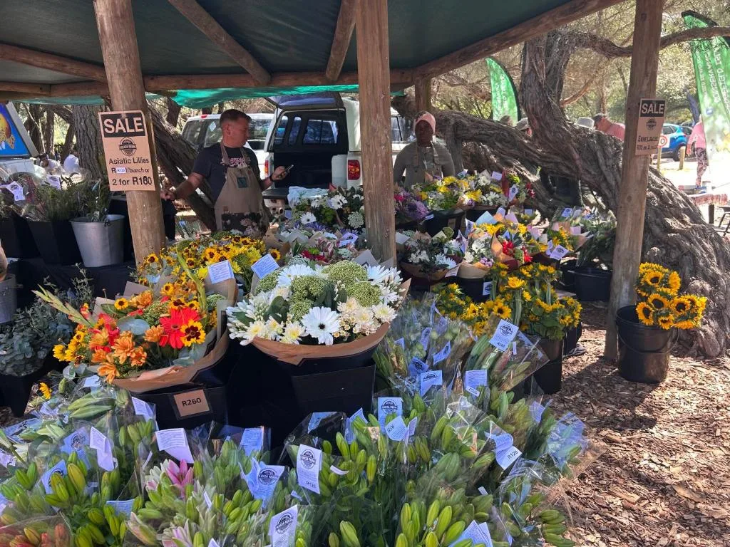 Flower market stall with colorful blooms and potted plants for sale