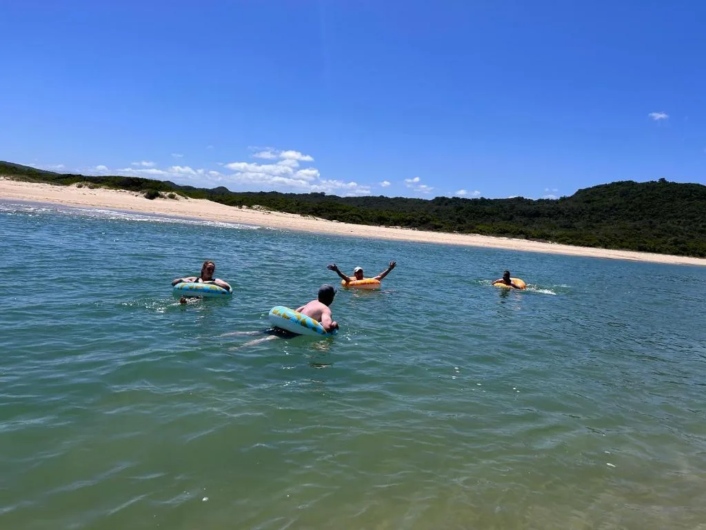 Pristine beach with swimmers and surfers enjoying clear turquoise waters