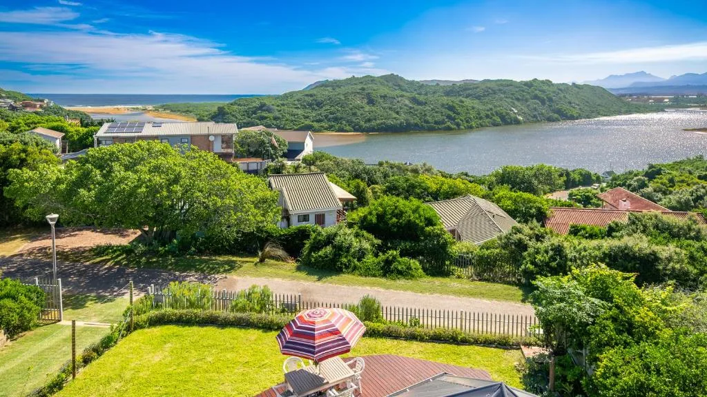 Scenic lagoon and mountain views from property grounds with umbrellas
