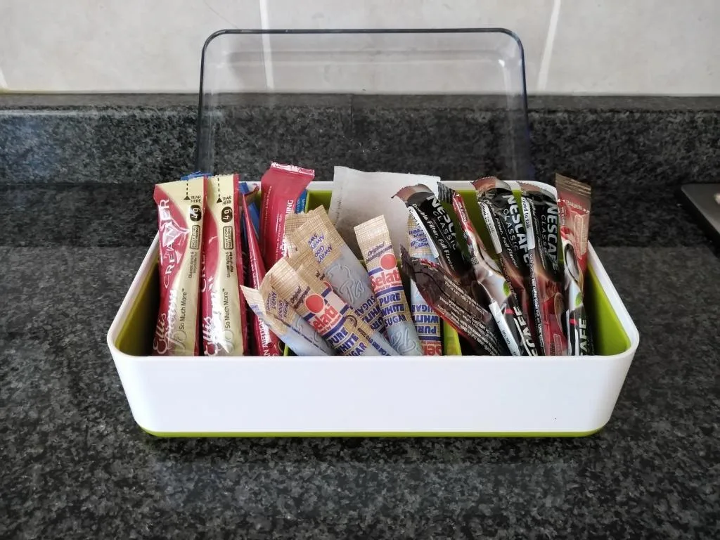 Welcome basket with assorted snacks and beverages on kitchen counter