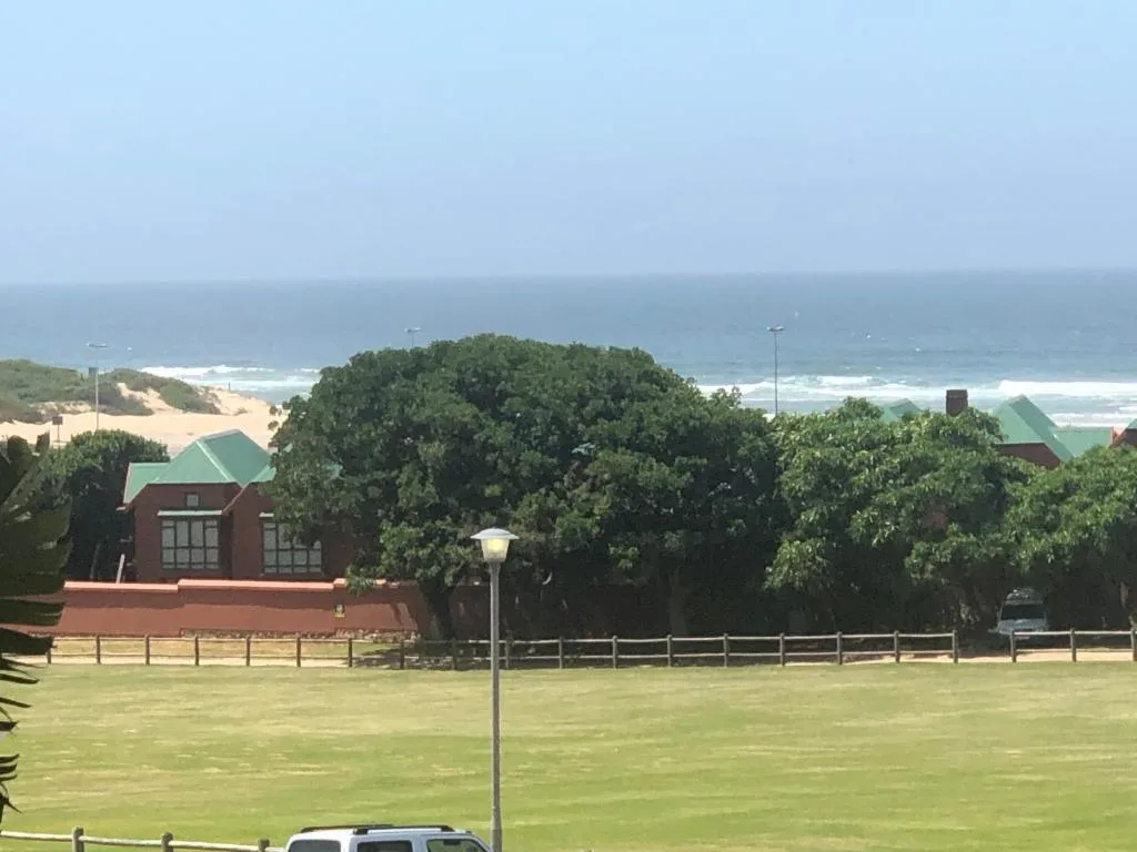 Scenic coastal view with beach, ocean, and dunes from property