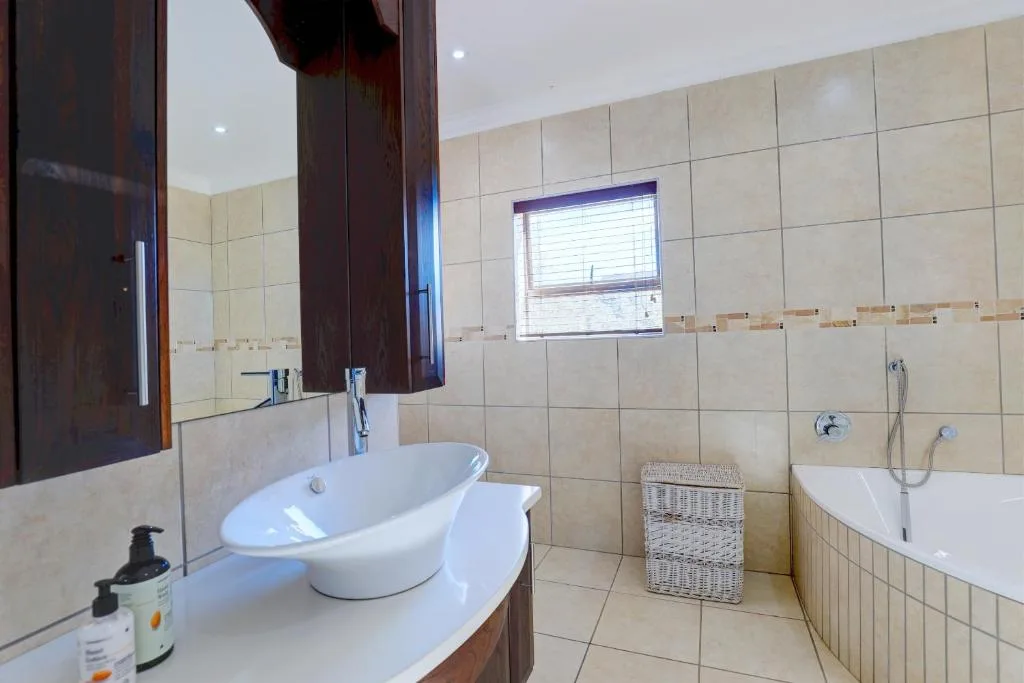 Spacious bathroom with dual vanities, oval soaker tub, and shower area