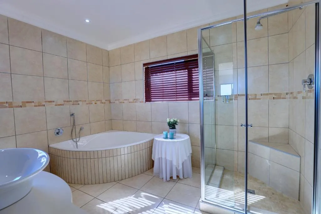 Spacious bathroom with soaking tub, walk-in shower, and dual vanities