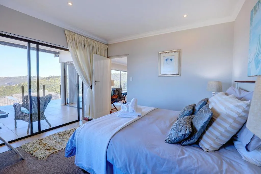 Spacious bedroom with king bed, patio doors opening to garden views