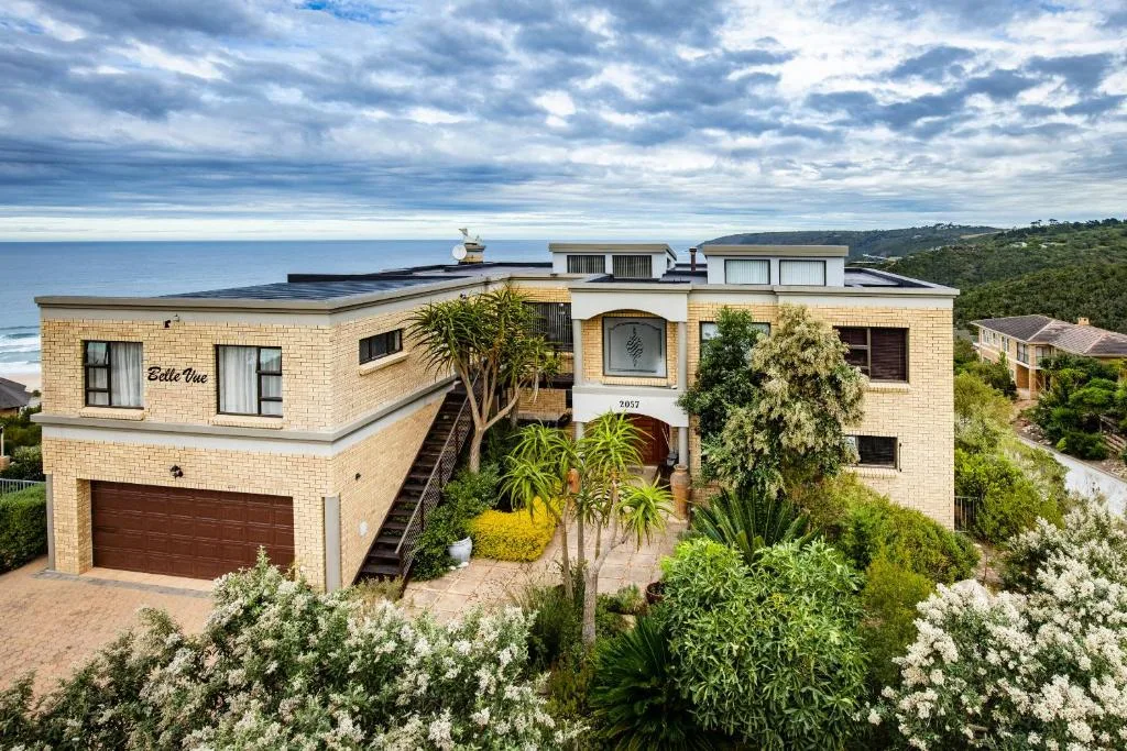 Modern brick home with ocean views, landscaped gardens, and coastal setting
