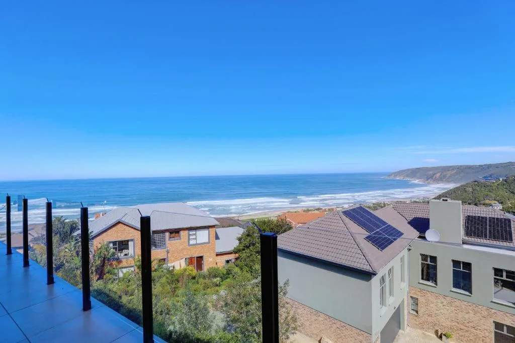 Panoramic ocean and coastline vista from elevated property outlook